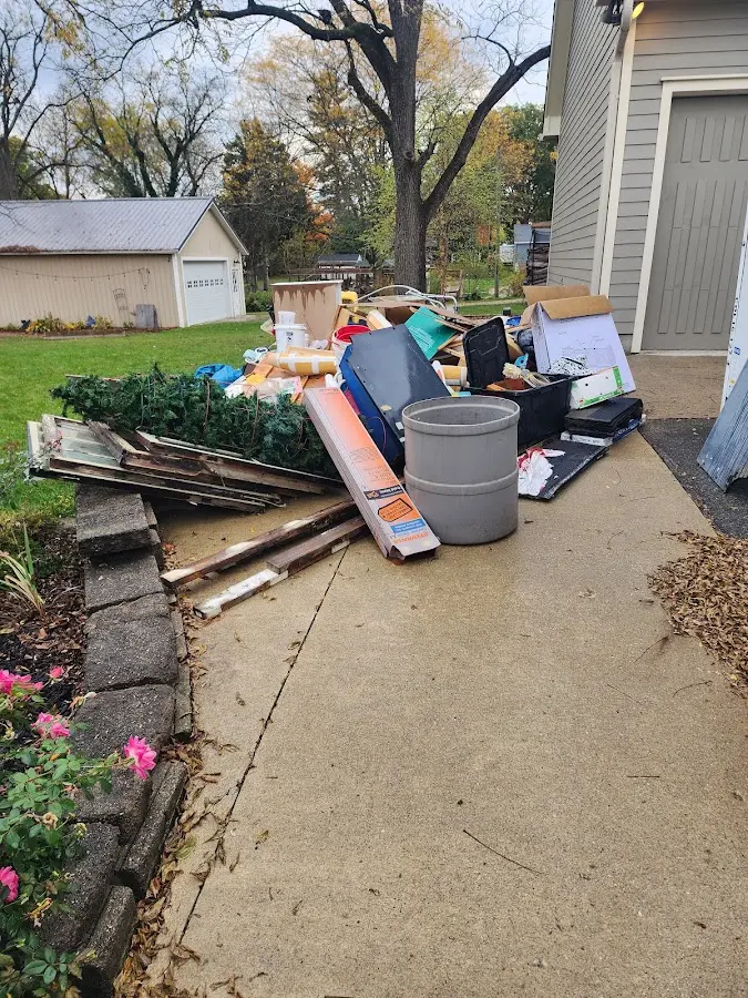 Dumpster being loaded with debris for Estate Cleanout Dumpster Rental in Cherokee Village